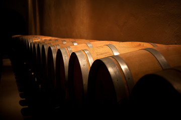 Row of wine barrels in an aging cellar