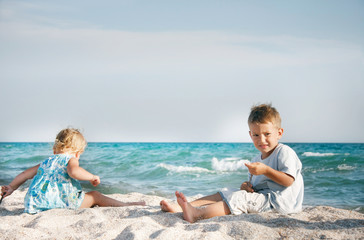 two children playing on sand beach
