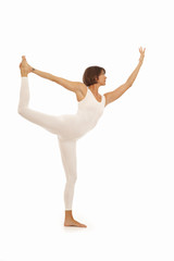 Obraz premium Young woman doing yoga Dancer Pose