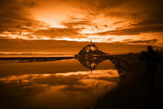 Mont Saint Michel reflected in the bay at sunset, France