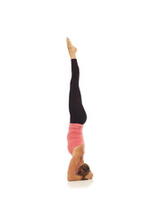 Young woman doing yoga Headstand Pose