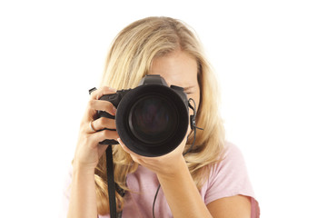 Young woman with camera taking a picture