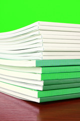 Pile of color magazines isolated on yellow background