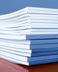 Fototapeta premium Pile of color magazines isolated on yellow background
