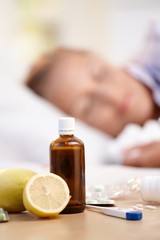 Vitamins medicines for flu woman in background