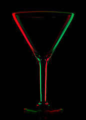 transparent colored empty martini glass on black