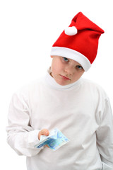 Small boy in Santa's red hat holding money isolated on white