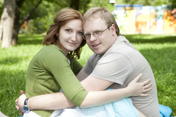 young couple sitting on grass