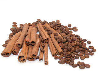 Cinnamon sticks and coffee beans on white background