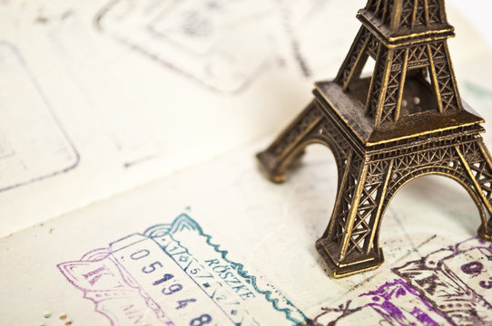 Stamped passport with Eiffel tower - travel to Paris concept -