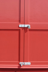 Locks on red beach hut. Hove Seafront. Sussex. England