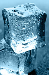 wet ice cubes on black glossy background