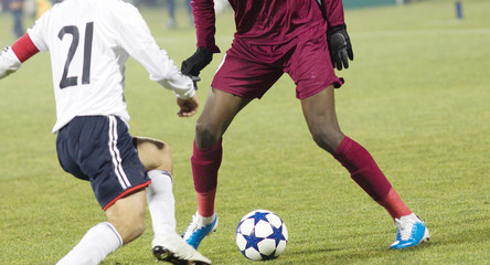 Soccer player running after the ball