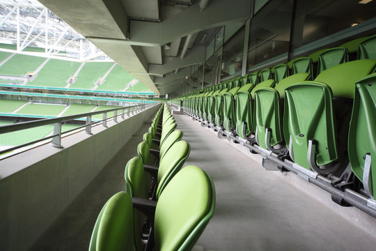 Many rows of folding seats in empty stadium