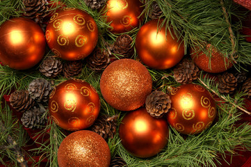 Colorful Christmas balls and cones on spruce branches