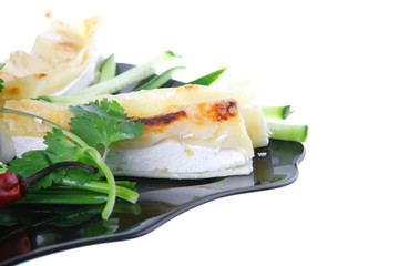 cheese cannelloni on black plate