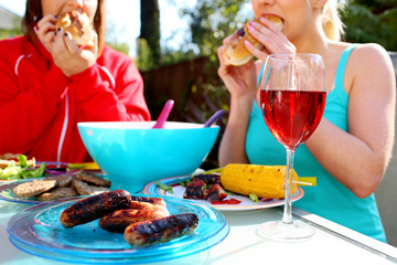Young Women Eating Hotdogs. Model Released