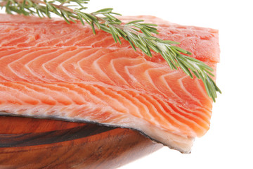 fresh uncooked salmon fillet on wooden plate
