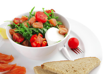 salad with smoked salmon in white bowl