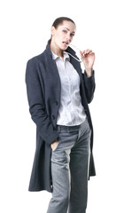 Naklejka premium A young businesswoman in a coat isolated on white