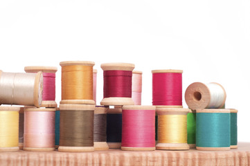 Various Spools of Colorful Thread on a White Background