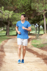 Young man running in park