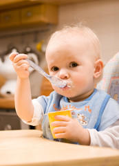 baby eating yoghurt © mbt_studio