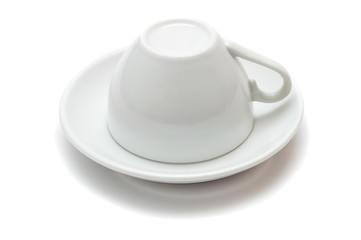 upside-down cup over saucer isolated on white background