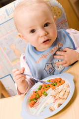 baby eating lunch - obrazy, fototapety, plakaty