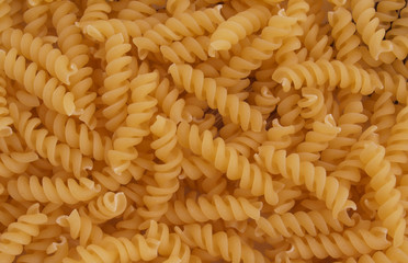 Italian uncooked spiral pasta with no background.