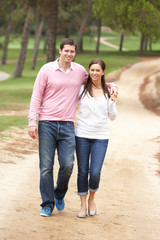 Romantic couple enjoying walk in park