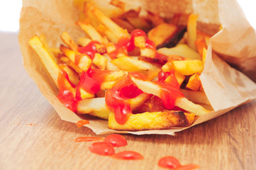 French fries drizzled with ketchup