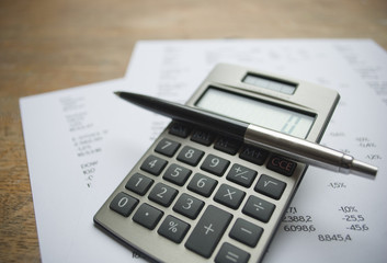 Calculator, pen and numbers