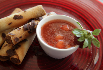 Mocha cigar cake pastry with strawberry mint sauce