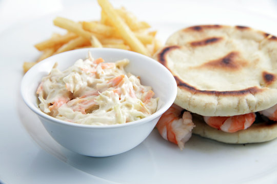 Seafood sandwich with coleslaw on white background