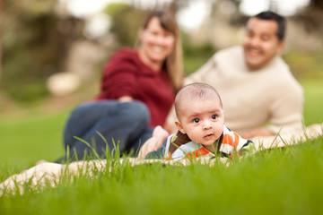 Naklejka na ściany i meble Happy Baby Boy and Mixed Race Parents Playing in the Park