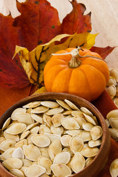 Vertical shot of toasted pumpkin seeds and autumn colors