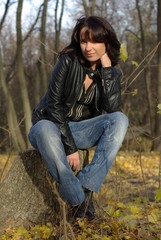 Girl sitting on a stump