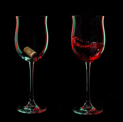 Red wine glasses with cork over black background.