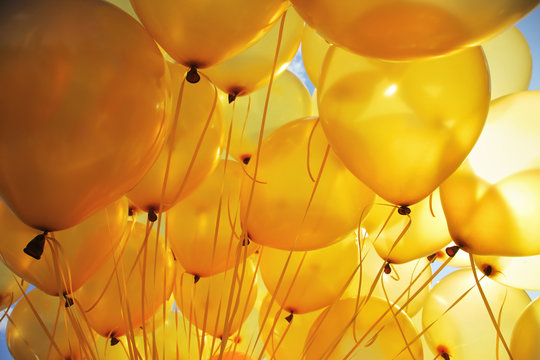 Inflatable yellow helium balloons party background