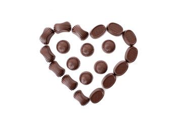 Chocolates in love shape isolated on white