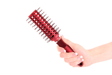 Hairbrush in hand isolated on white