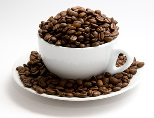 Mug filled with coffee beans
