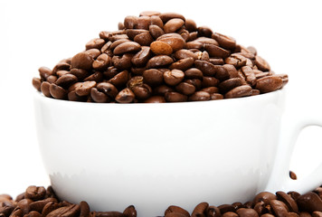 Mug filled with coffee beans