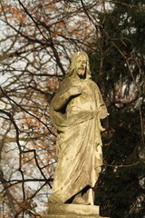 figure of Jesus in sunlight on ancient cemetery