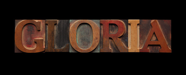 the word gloria in old wood type on black - obrazy, fototapety, plakaty