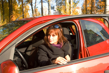 Girl with sunglass in the red car