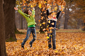 Kids jumping in autumn park