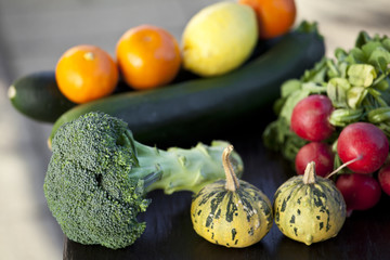 Świeże warzywa: brokuł, dynia, rzodkiew, cukinia na stole - obrazy, fototapety, plakaty