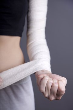 Strong girl's body with with elastic bandage on hand.